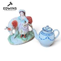 A Staffordshire Figure, milkmaid and cow; together with an 18th-century English soft-paste porcelain