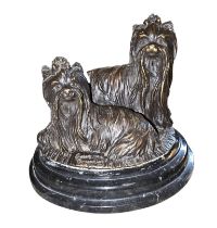 A late 19th/early 20th-century French bronze group of two Yorkshire Terriers, one modelled recumbent