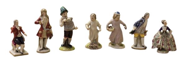 A collection of Continental and English Porcelain Miniature Figures, comprising a Chelsea red anchor