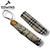 A Burberry Check Folding Umbrella, in the beige check pattern, with Burberry engrained on the wooden