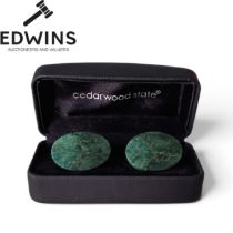 A Cased Set of green marble cufflinks displayed inside a black presentation box branded with "