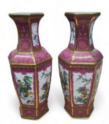 A pair of Chinese hexagonal baluster 'famille rose' porcelain vases,  with monumental landscape in
