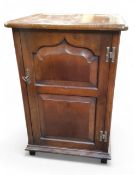 A Batheaston Furniture oak side cabinet, hinged top, panelled door, 73cm high, 49cm wide, 45cm deep