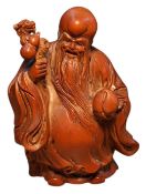 A Chinese boxwood figure, of Shou Xing Gong, Chinese God of Longevity, holding a peach of