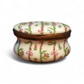 An early 20th century French Limoges style gilt metal mounted trinket box, decorated with ribbon
