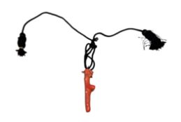 Jewellery - a polished coral branch pendant, 9.5cm long, suspended on a cotton necklace