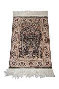 A Turkish Hereke silk prayer rug, with vase of flowers, stylised deers and birds, 92cm long, 63cm