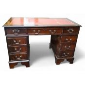 A George III style mahogany twin pedestal desk, tooled leather writing surface,  with three frieze