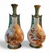 A pair of Royal Worcester two-handled Persian baluster vases, decorated in relief in gilt with