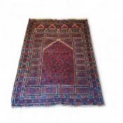 An Afghan Baluch woollen rug, with geometrical patterns, in deep red, navy, brown and cream, 130cm x