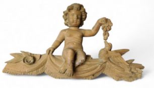 An 18th century carved softwood cresting, of a putt seated on a swag feeding a bird, 37cm high, 61cm