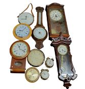 An early 20th century oak aneroid barometer, mercury thermometer, carved with stylised leaves,