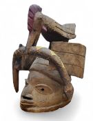 Tribal Art - a Yoruba Gelede helmet mask, elliptical eyes, hand-painted features, stylised bird