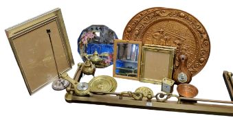 An early 20th century  brass  fire surround, 131cm wide;  a shaped circular 'Gypsy' mirror,