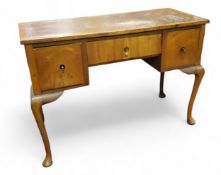 An early 20th century walnut writing desk, tooled leather top, the frieze with one long and two deep