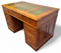 A Victorian style mahogany kneehole twin pedestal desk, inlaid gilt-tooled leather writing skiver,