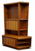 A G-Plan herringbone teak wall unit, open glass shelf above fall front and cupboard doors, canted