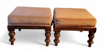 A pair of Victorian mahogany footstools, stuffed-over seats, turned legs, 24cm high, the tops 30cm