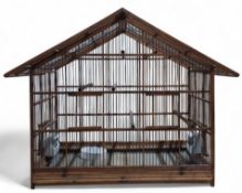 A late 19th/early 20th century West German? wooden birdcage in the form of a house, complete with