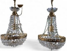 A pair of Regency style gilt metal and glass bag chandeliers, (af) not checked for completeness,