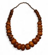 Tribal Art - a Baltic bead amber type necklace, graduated beads, approx 70cm long