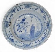An 18th century enamel chinoiserie dished plate, in blue with figure and stylised foliage, 22.5cm