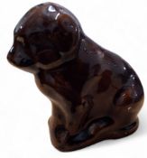 A Victorian treacle glazed money box, in the form of a seated dog, 10cm high, c.1880