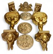 A pair of gilt plaster Reynolds Angels wall brackets, 19cm high;   other;  three similar discs;