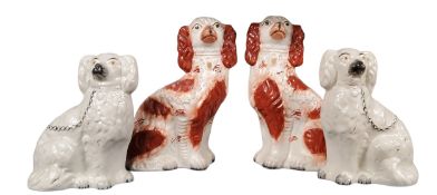 A pair of Victorian Staffordshire dogs, seated to the left and right, rust coat markings, 35cm high,