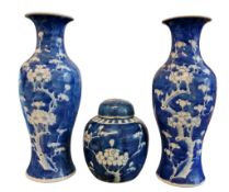 A pair of Chinese baluster vases, decorated with blossoming prunus on a blue ground, 29.5cm high,