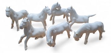 Seven Blanc de Chine horses, various poses, the tallest 7cms, some  crazed