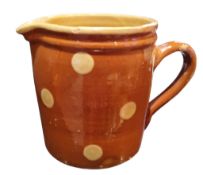 Folk Art/Kitchenalia - a French terracotta Savoie cream polka dot glazed jug, 12cm high