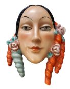 An Art Deco Goebel wall mask, of a lady, red and blue ringlets, 17cm high, impressed mark
