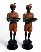A pair of Venetian style bronze painted Blackamoor figures, standing, holding trays, each wearing
