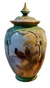A Royal Worcester Hadley Ware lobed ovoid vase and cover, decorated by W.E. Jarman, signed, with
