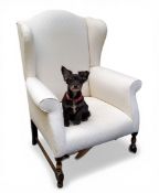 A late 19th/early 20th century wingback armchair, in the William and Mary style,  the arched back