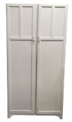 An early 20th century white painted double panelled door wardrobe, the interior with hanging rail