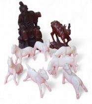 Seven Blanc de Chine horses, various poses, the tallest 7cms, some  crazed;   a Chinese hardwood