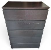 A contemporary black chest, of two short and four long drawers, 123cm high, 80cm wide, 49cm deep
