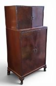An early 20th century walnut cabinet, retailed by J.W.C. Hydes, Sheffield, the top with two cupboard