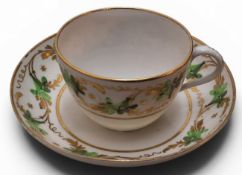 A Pinxton Bute teacup and saucer, pattern No. 312, decorated in green and gilt with bands of
