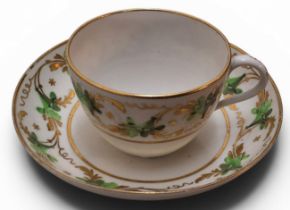 A Pinxton Bute teacup and saucer, pattern No. 312, decorated in green and gilt with bands of