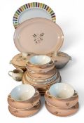 A Poole Leaping Deer dinner service, each with stylised deer and foliage on a pink ground,