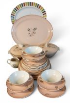 A Poole Leaping Deer dinner service, each with stylised deer and foliage on a pink ground,