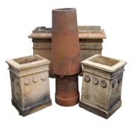 A pair of Edwardian chimney pots, of tapered rectangular form, the frieze with moulded roundels,