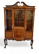An early 20th century mahogany and inlaid bow and incurved centre display cabinet, inlaid in