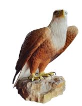 A Royal Crown Derby model, Eagle, naturalistically modelled, on a rock, 25.5cm high, printed mark in