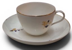 A Pinxton Bute teacup and saucer, pattern no.46, decorated with cornflowers and gilt sprigs, gilt