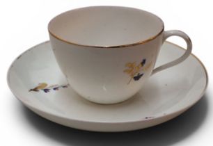A Pinxton Bute teacup and saucer, pattern no.46, decorated with cornflowers and gilt sprigs, gilt