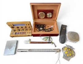 A Festival of Britain 1951 chrome plated cigarette/cheroot case;     a graduated set of weights,